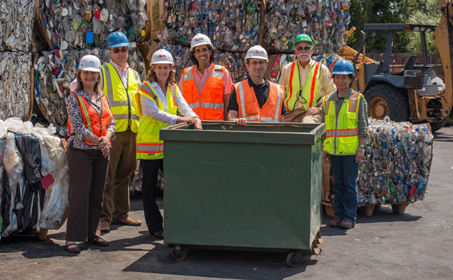 People standing in recycling facility
